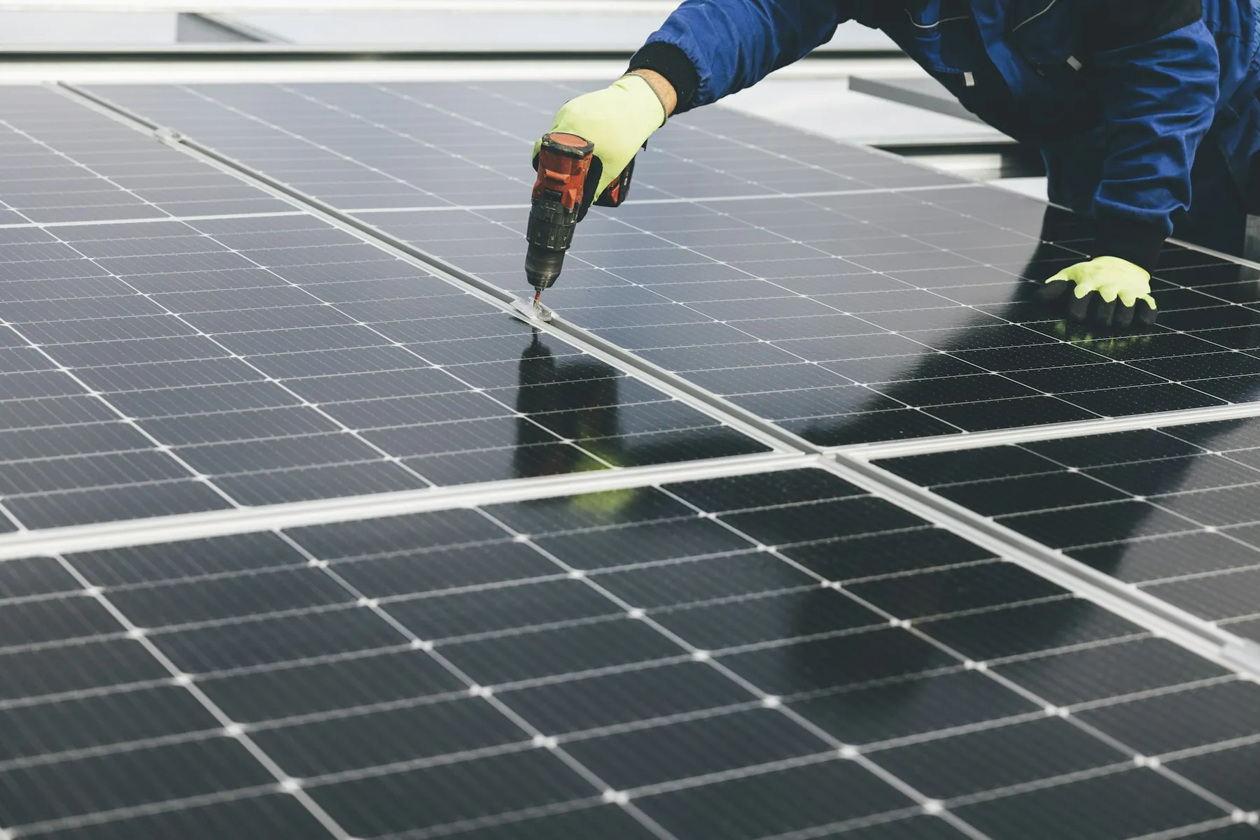 Installer fixing a solar panel in place